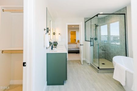 Interior of a master bathroom and custom green bathroom vanity