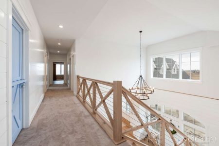 Interior of upper level hallway and loft area that overlooks the lower level living area