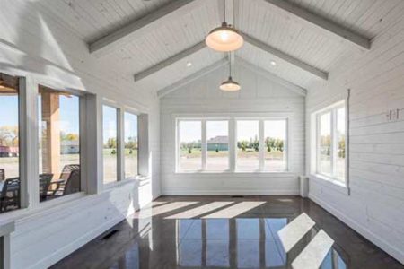 Large sunroom full of natural light with views of the open backyard